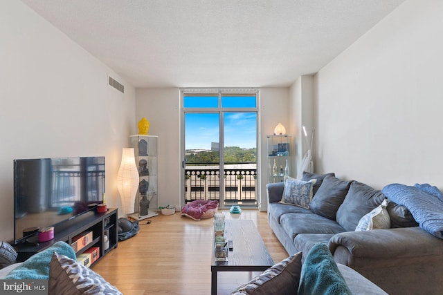 155 Potomac Psge Unit 817, Oxon Hill, MD 20745 - living room featuring a wall of windows and wood finished floors