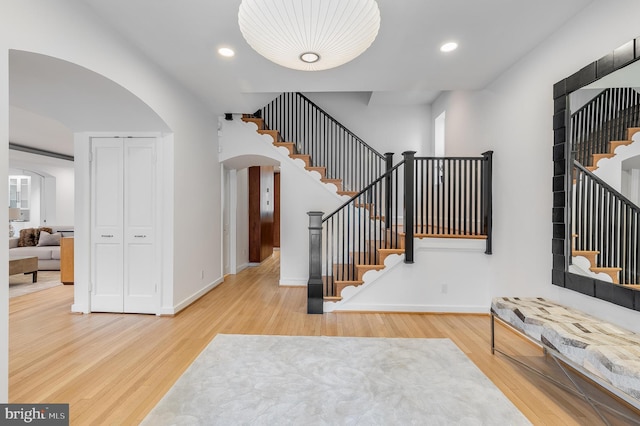 2950 Macomb St NW, Washington, DC 20008 - entryway with arched walkways, stairway, wood finished floors, baseboards, and recessed lighting