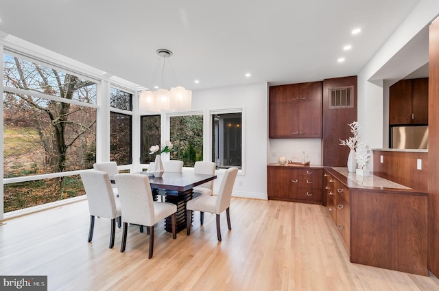2950 Macomb St NW, Washington, DC 20008 - dining room featuring light wood-style floors, recessed lighting, a chandelier, and baseboards
