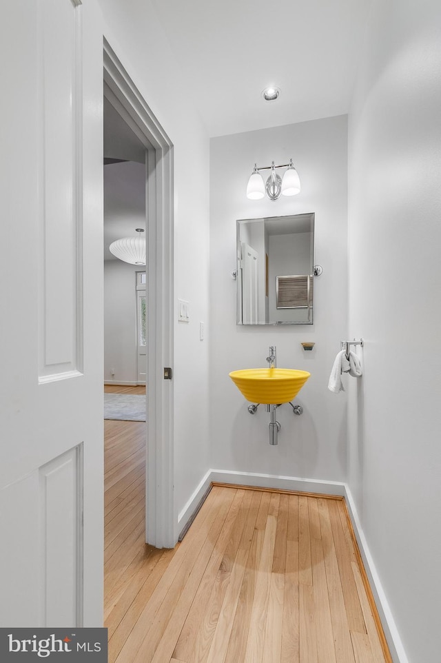 2950 Macomb St NW, Washington, DC 20008 - bathroom with hardwood / wood-style floors, a sink, and baseboards