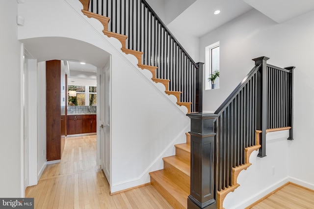 2950 Macomb St NW, Washington, DC 20008 - staircase featuring wood-type flooring, arched walkways, baseboards, and recessed lighting