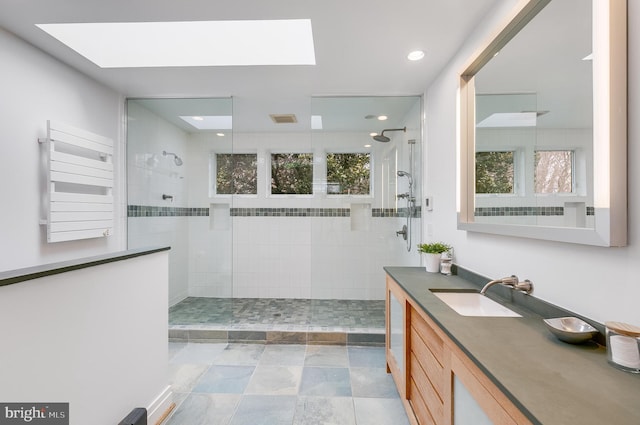 2950 Macomb St NW, Washington, DC 20008 - bathroom featuring radiator, a skylight, vanity, walk in shower, and recessed lighting