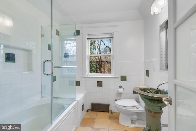 2950 Macomb St NW, Washington, DC 20008 - bathroom with toilet, tile walls, tile patterned floors, and enclosed tub / shower combo
