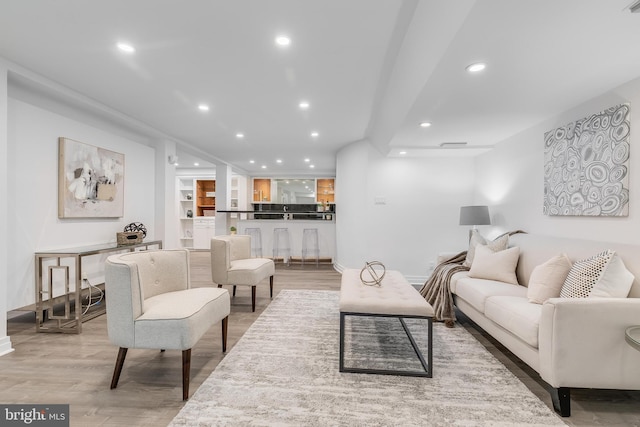 2950 Macomb St NW, Washington, DC 20008 - living room featuring recessed lighting, light wood-type flooring, bar area, and baseboards