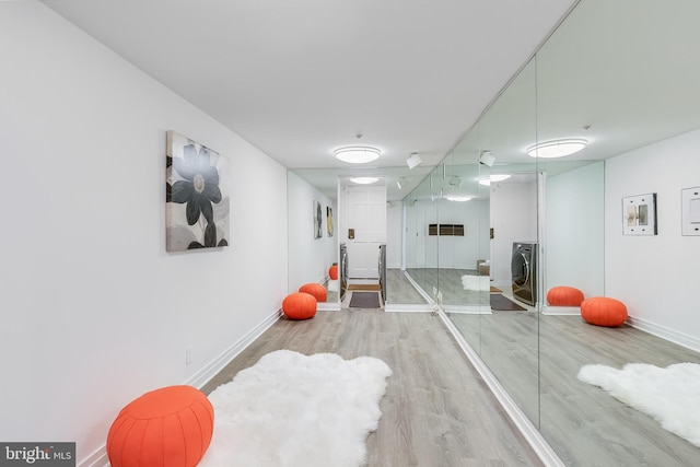 2950 Macomb St NW, Washington, DC 20008 - workout room with wood finished floors, baseboards, and washer / clothes dryer