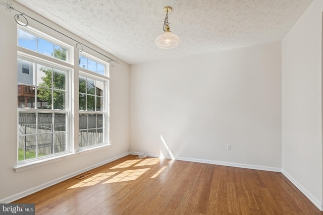 8309 Pigeon Fork Ln, Laurel, MD 20724 - spare room with wood finished floors and a textured ceiling
