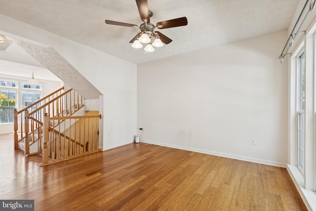 8309 Pigeon Fork Ln, Laurel, MD 20724 - unfurnished living room featuring wood finished floors, ceiling fan, and a textured ceiling