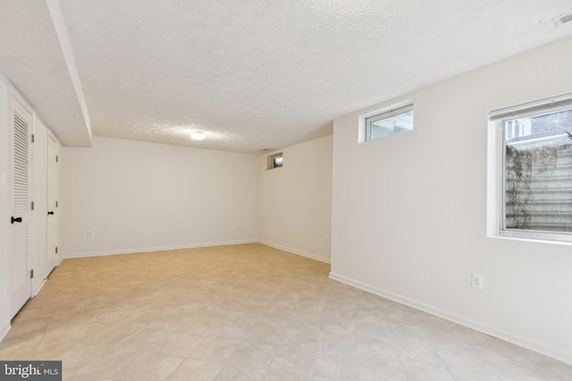 8309 Pigeon Fork Ln, Laurel, MD 20724 - below grade area with a textured ceiling and baseboards