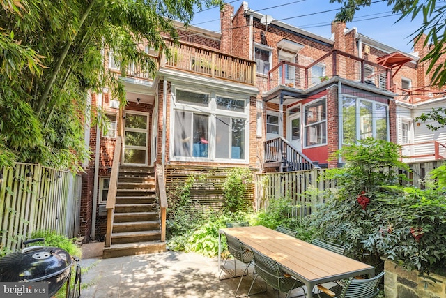 1850 Irving St NW, Washington, DC 20010 - rear view of house with brick siding, a balcony, a patio area, and stairs