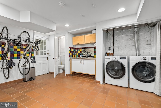 1850 Irving St NW, Washington, DC 20010 - washroom featuring washing machine and dryer, light tile patterned floors, and recessed lighting