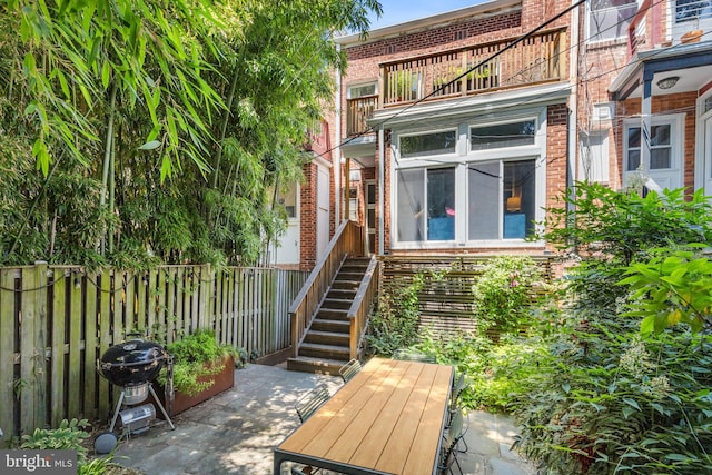1850 Irving St NW, Washington, DC 20010 - rear view of property featuring brick siding, stairs, a patio area, and a balcony