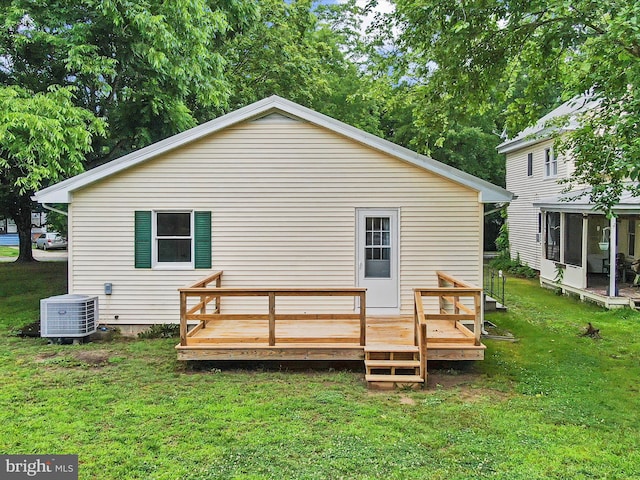 213 S 6th St, Denton, MD 21629 - rear view of house with a sunroom, a wooden deck, and a yard