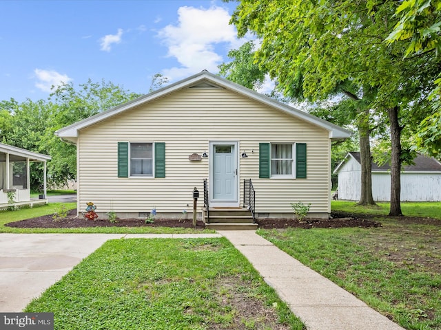 213 S 6th St, Denton, MD 21629 - bungalow featuring a front lawn