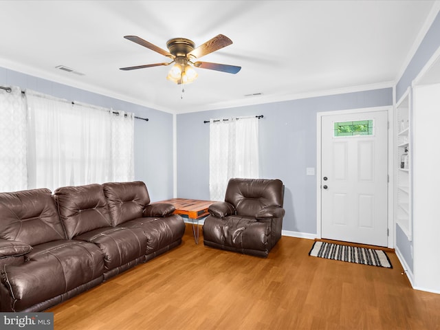 213 S 6th St, Denton, MD 21629 - living room featuring light wood-style flooring, ceiling fan, and ornamental molding
