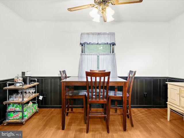 213 S 6th St, Denton, MD 21629 - dining room with wood finished floors, ceiling fan, a wainscoted wall, and ornamental molding