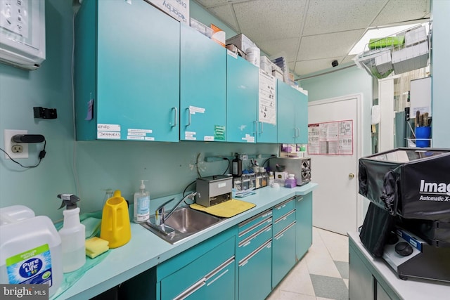 3 W Gowen Ave, Philadelphia, PA 19119 - kitchen with a sink, a drop ceiling, light countertops, and blue cabinetry