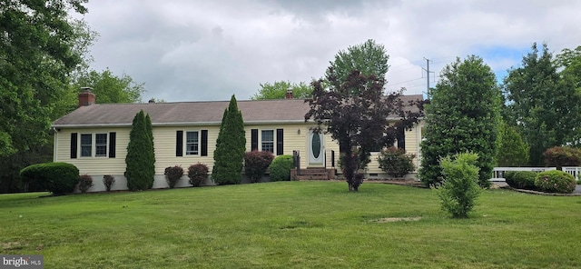 view of front of property featuring a front yard, a chimney, and crawl space