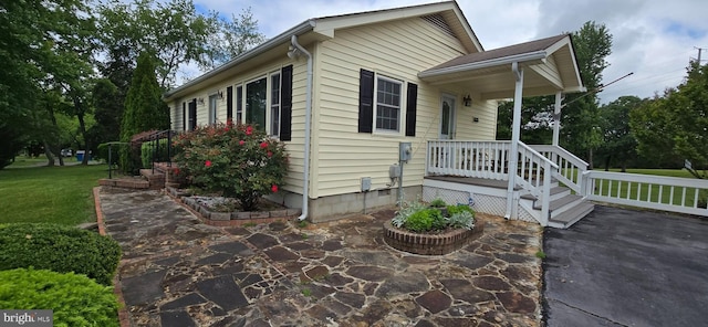 view of property exterior with a yard and a patio area