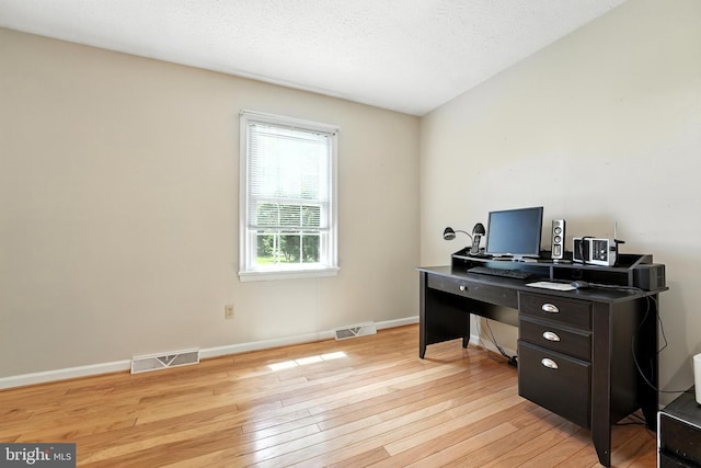 office with light wood-style flooring