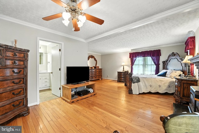 bedroom featuring a textured ceiling, light wood-style flooring, ornamental molding, ensuite bath, and ceiling fan