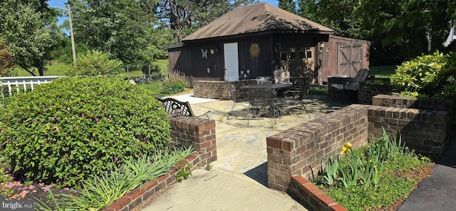 view of patio with an outbuilding