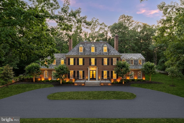 13300 Manor Stone Dr, Darnestown, MD 20874 - view of front of home featuring french doors, a chimney, a yard, and curved driveway
