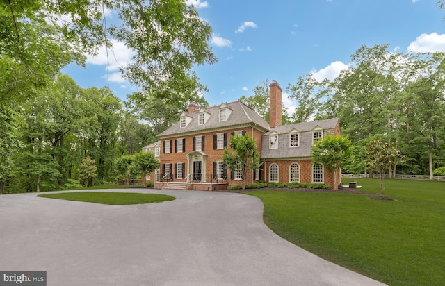 13300 Manor Stone Dr, Darnestown, MD 20874 - colonial house with a front yard, brick siding, and a chimney