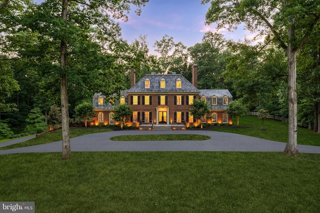 13300 Manor Stone Dr, Darnestown, MD 20874 - colonial inspired home featuring curved driveway, a high end roof, a chimney, a front yard, and brick siding