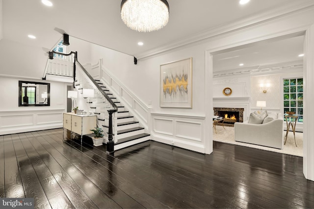 13300 Manor Stone Dr, Darnestown, MD 20874 - living room featuring a decorative wall, stairs, dark wood-style floors, a premium fireplace, and crown molding