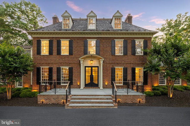 13300 Manor Stone Dr, Darnestown, MD 20874 - colonial-style house featuring a chimney, a high end roof, brick siding, and french doors