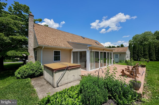 1549 Willoughby Cir, Manheim, PA 17545 - back of house featuring a hot tub, a chimney, a sunroom, a shingled roof, and a patio area