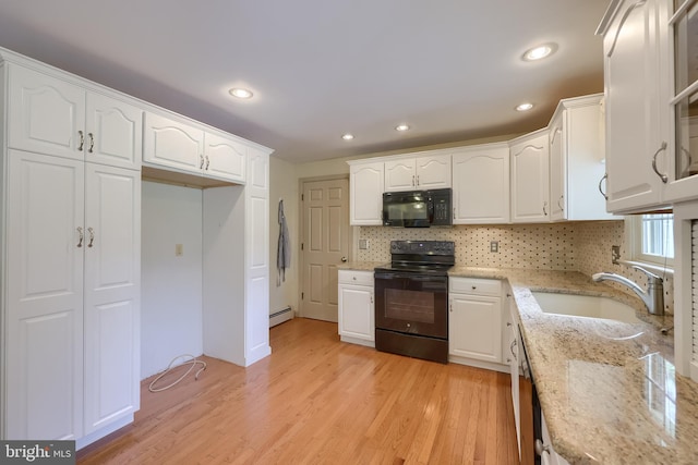 1549 Willoughby Cir, Manheim, PA 17545 - kitchen featuring black appliances, white cabinetry, a baseboard radiator, light stone countertops, and light wood-type flooring