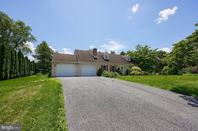 1549 Willoughby Cir, Manheim, PA 17545 - cape cod house with an attached garage, a front lawn, driveway, and a chimney