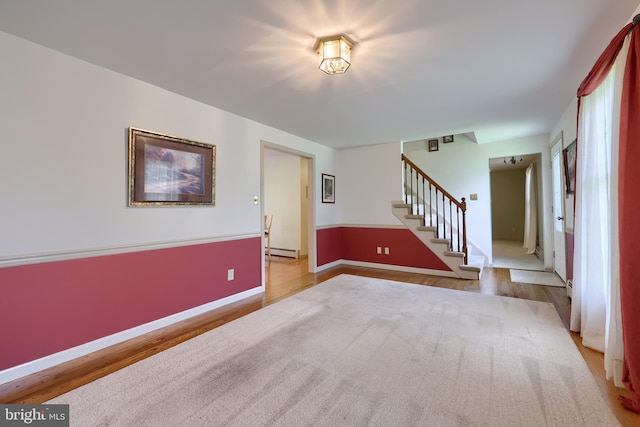 1549 Willoughby Cir, Manheim, PA 17545 - unfurnished living room with a baseboard radiator, stairs, and wood finished floors