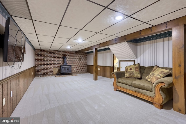 1549 Willoughby Cir, Manheim, PA 17545 - carpeted living room featuring a wood stove, wainscoting, wooden walls, and a paneled ceiling