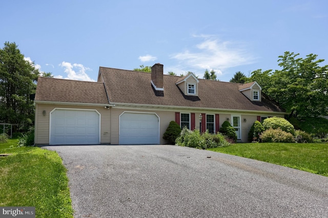1549 Willoughby Cir, Manheim, PA 17545 - cape cod home with a garage, asphalt driveway, a front lawn, and a chimney