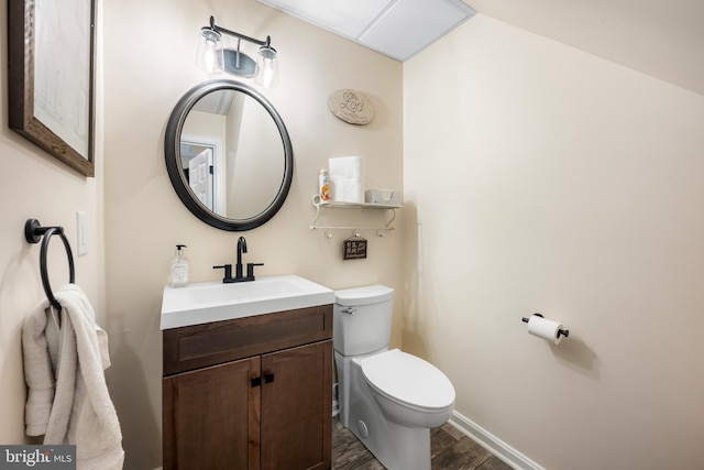 2997 Patapsco Rd, Finksburg, MD 21048 - bathroom with toilet, vanity, wood finished floors, and baseboards