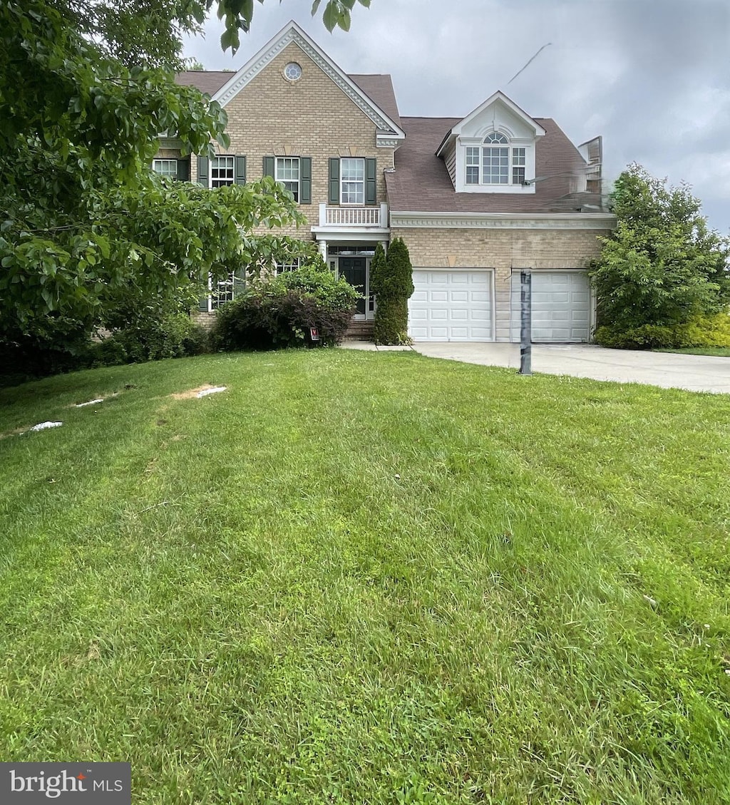 13014 Woodmore N Blvd, Bowie, MD 20720 - colonial-style house featuring a garage, concrete driveway, a front yard, and brick siding