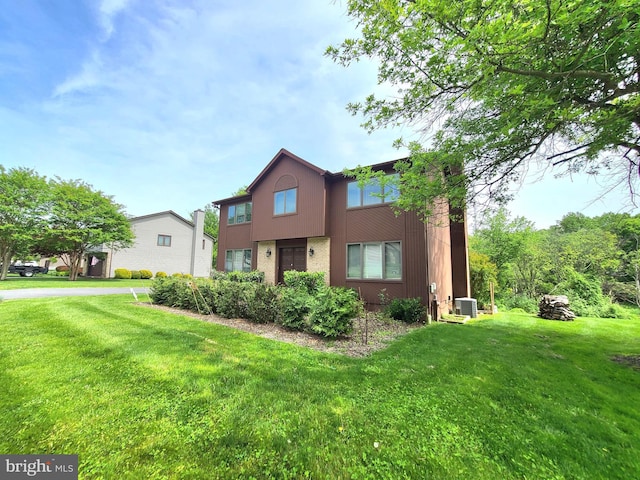 3747 Spring Lake Ln, Owings Mills, MD 21117 - view of front of property featuring central AC, a front lawn, and stucco siding