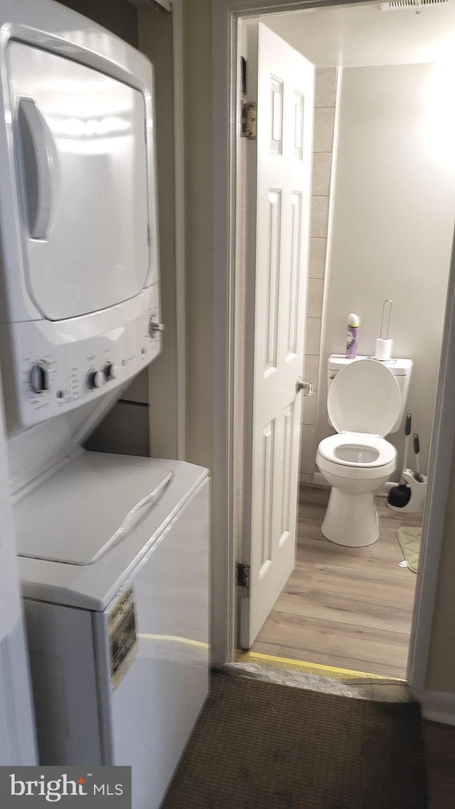 7143 Donnell Pl Unit C, District Heights, MD 20747 - laundry room featuring stacked washer / dryer and wood finished floors