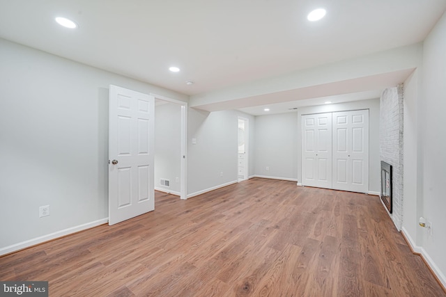 4721 Springbrook Dr, Annandale, VA 22003 - finished basement featuring wood finished floors, a brick fireplace, and recessed lighting