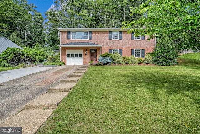 4721 Springbrook Dr, Annandale, VA 22003 - view of front facade with asphalt driveway, a garage, a front lawn, and brick siding