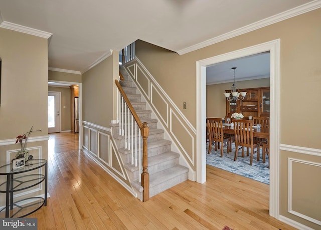 365 Newgate Rd, Langhorne, PA 19047 - stairs with wood-type flooring, crown molding, and a chandelier