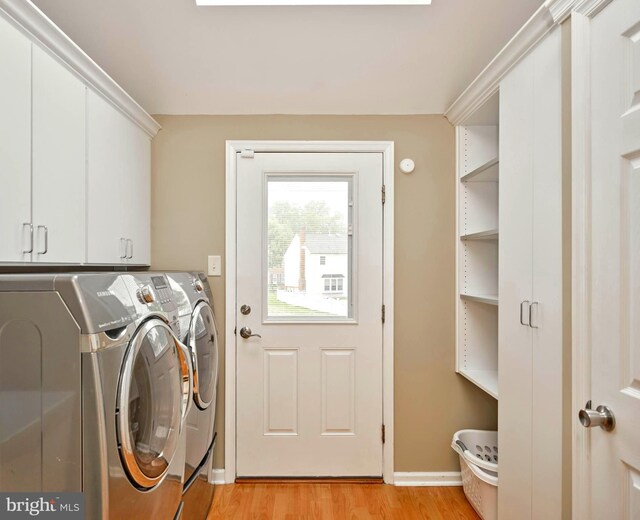 365 Newgate Rd, Langhorne, PA 19047 - laundry area with washer and clothes dryer, cabinet space, and light wood-type flooring