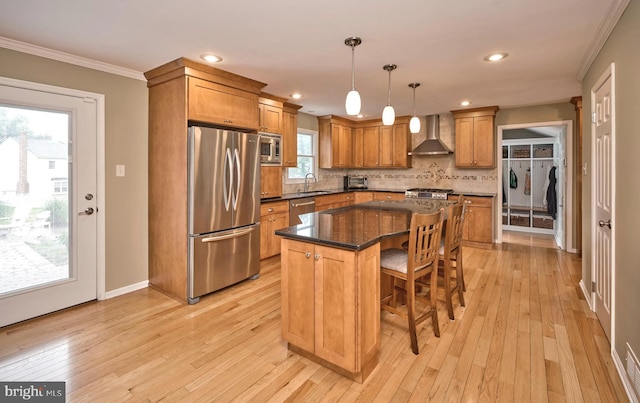 365 Newgate Rd, Langhorne, PA 19047 - kitchen with stainless steel appliances, wall chimney range hood, ornamental molding, light wood finished floors, and tasteful backsplash