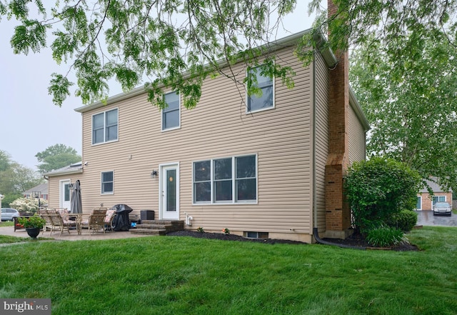 365 Newgate Rd, Langhorne, PA 19047 - rear view of house featuring a yard, a patio area, and a chimney