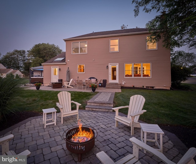 365 Newgate Rd, Langhorne, PA 19047 - back of house at dusk with a fire pit, a patio, a yard, and entry steps