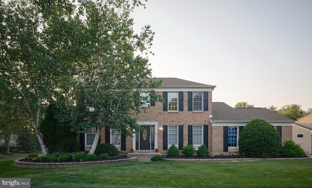 365 Newgate Rd, Langhorne, PA 19047 - colonial-style house with brick siding, a front yard, and roof with shingles