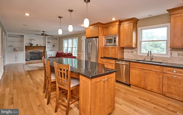 365 Newgate Rd, Langhorne, PA 19047 - kitchen featuring stainless steel appliances, brown cabinets, light wood-type flooring, ornamental molding, and recessed lighting