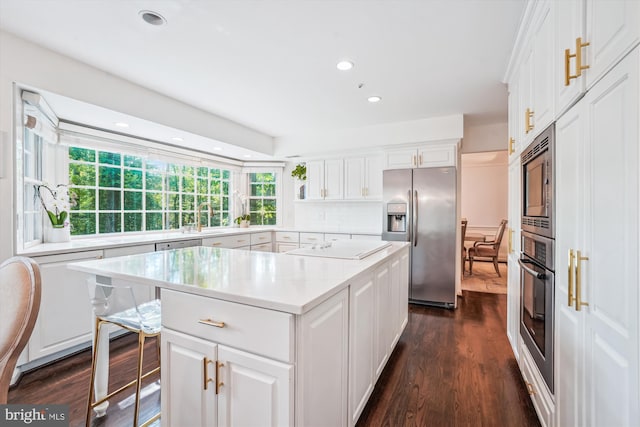 1399 Old Quincy Ln, Reston, VA 20194 - kitchen with appliances with stainless steel finishes, light countertops, a center island, white cabinetry, and recessed lighting